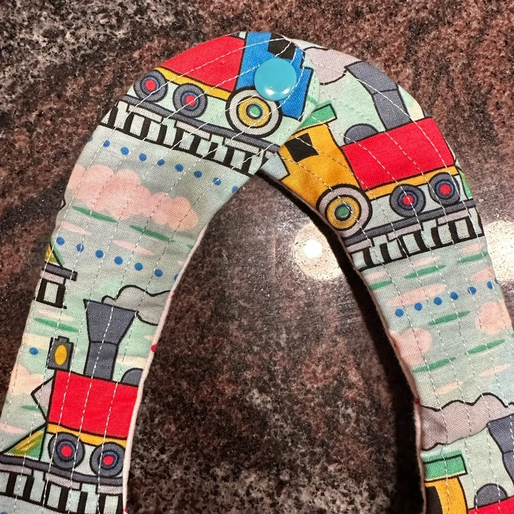Handmade reversible quilted baby bib with train design
